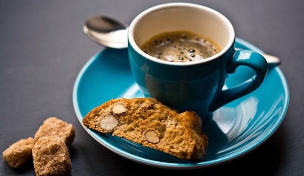 Tasse Espresso mit Cantuccini auf einem türkisfarbenen Teller